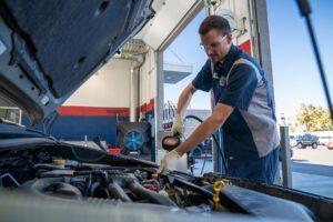Burt Brothers technician conducting an oil change service on a vehicle.