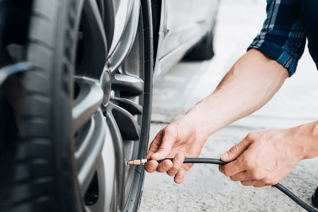 A person filling a tire with a tire pump